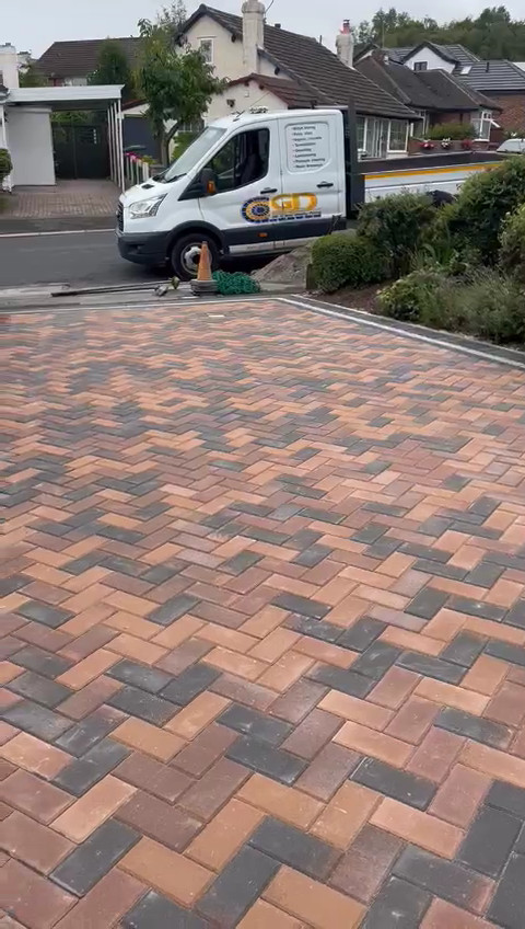 Contrast light and dark reds blockwork driveway.